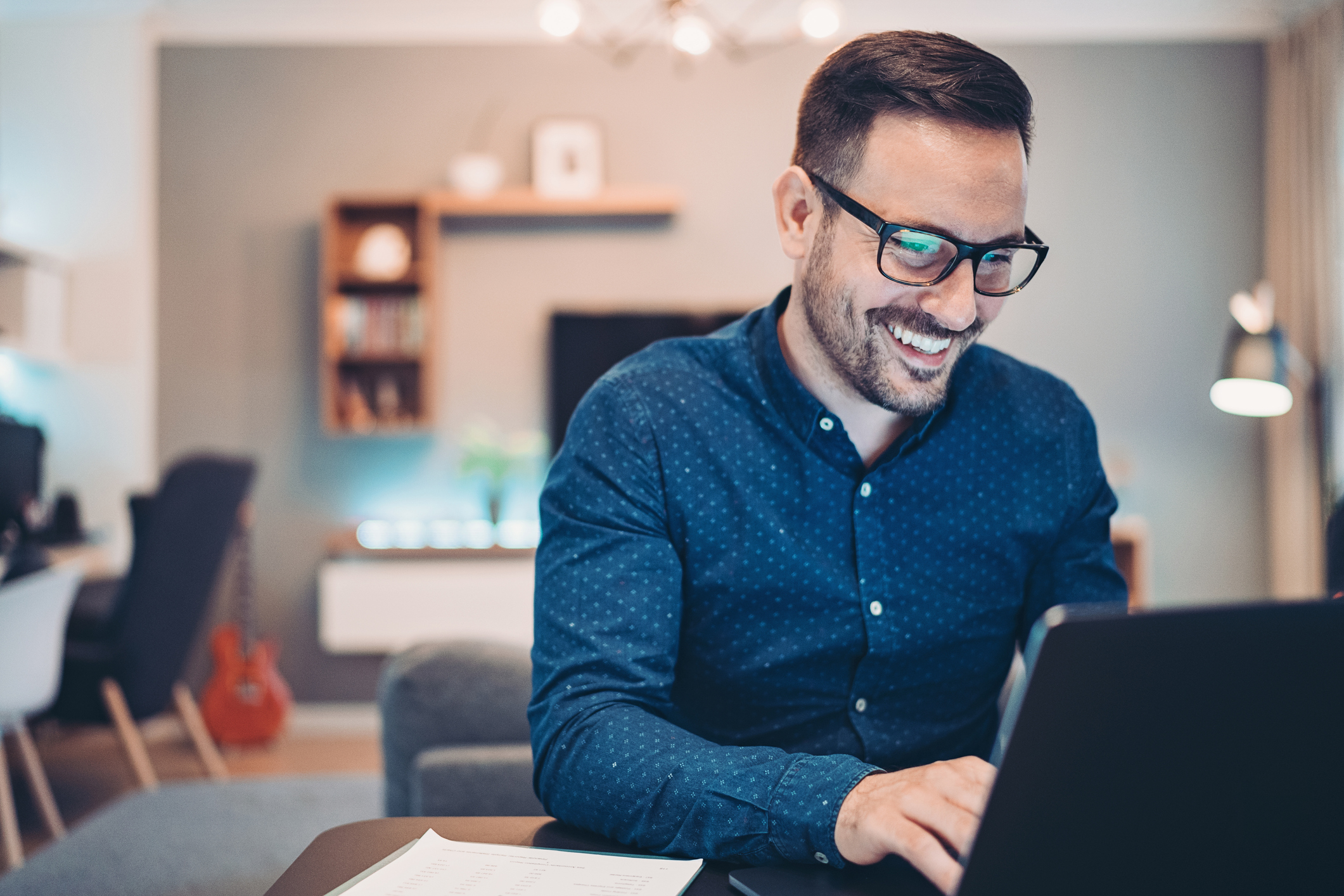 Young man working at home in the evening