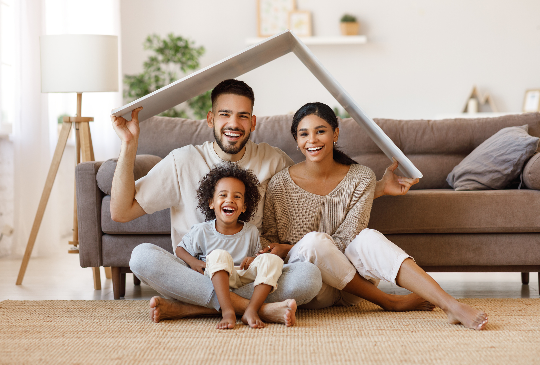 Happy family under fake roof in living room